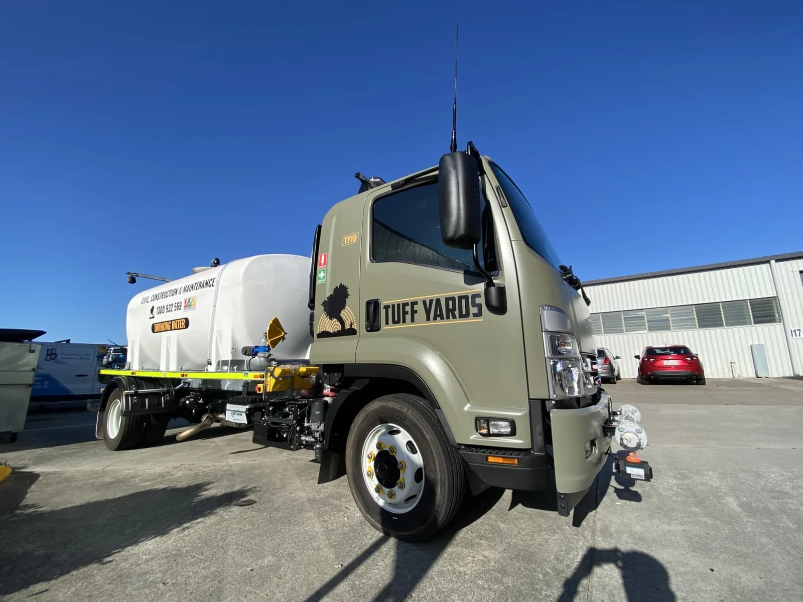 Tuff Yards water truck with cab signage and door graphics